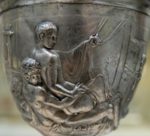 Embossed Roman cup showing two naked men, the young man being anally penetrated by the older.