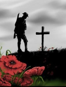 Silhouette of a soldier with rifle standing beside a grave with wooden cross. Two red poppies in foreground.
