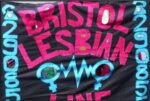 A flag banner with text "Bristol Lesbian Line" in red, and blue phone number "29085" on a black background.
